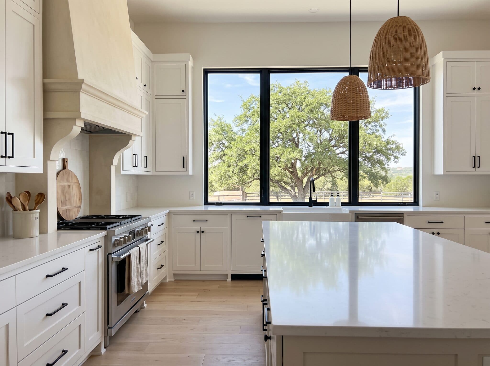 A spotless farmhouse kitchen with a window looking out on a live oak