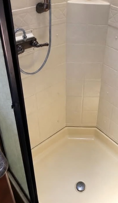 The same shower after Maria cleaned it, with the streaks and stains gone
